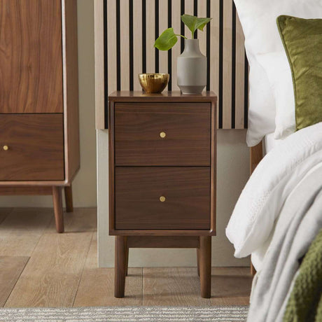 Fishe and Lilly Bedside Table in walnut finish with two drawers and stylish decor beside a bed
