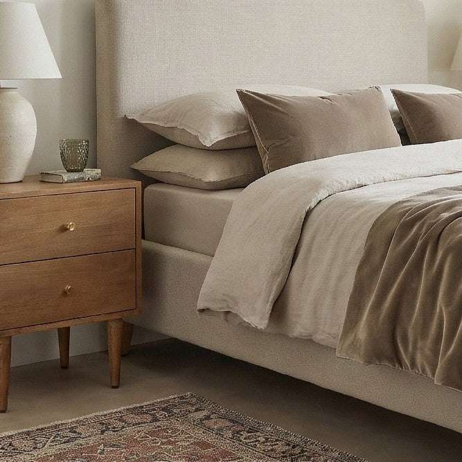 Fishe and Lilly wooden Bedside Table with two drawers and lamp beside a plush bed with neutral bedding