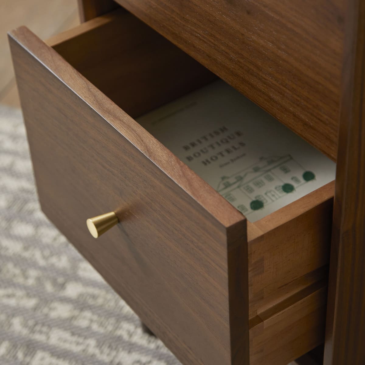 Fishe and Lilly Bedside Table featuring a drawer with a stylish brass handle and a magazine inside