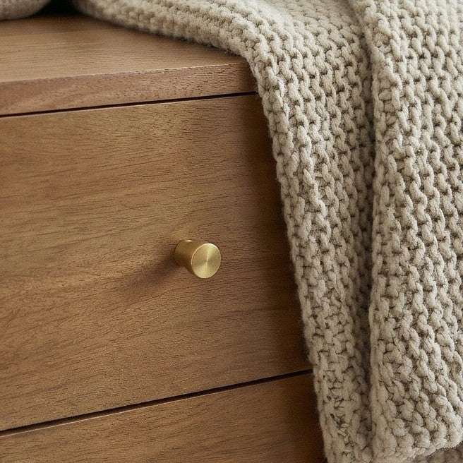 Fishe and Lilly Bedside Table in natural wood finish with a textured throw draped on top