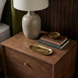 Fishe and Lilly Bedside Table in walnut finish with a lamp and decorative items on top
