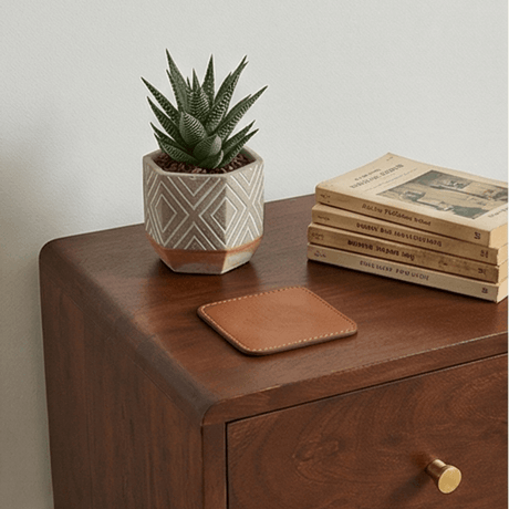 Fishe and Lilly bedside table in rich wood finish with decorative plant and stacked books