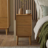Fishe and Lilly Bedside Table in oak finish with two drawers and decorative vase