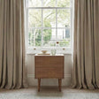 Fishe and Lilly Bedside Table in Natural Wood Beside a Window with Decorative Items