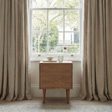 Fishe and Lilly Bedside Table in Natural Wood Beside a Window with Decorative Items