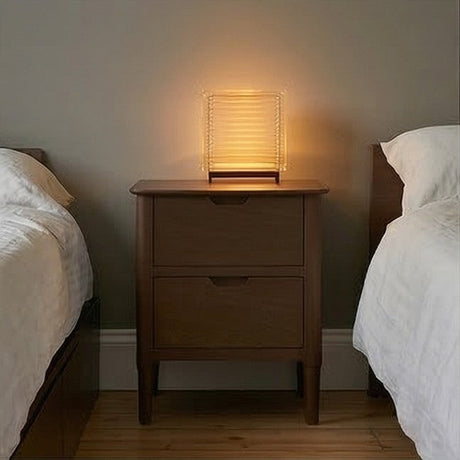 Fishe and Lilly Bedside Table with two drawers and a soft glowing lamp in a cosy bedroom