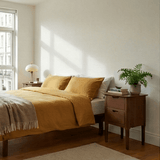 Fishe and Lilly Bedside Table in elegant wooden finish beside a cosy bed in a modern bedroom