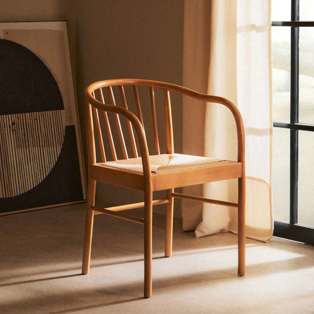 Orsina Beech Wood Chair with a curved design and soft fabric cushion in a stylish living space