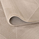 Close-up of a soft textured beige rug with a modern geometric pattern