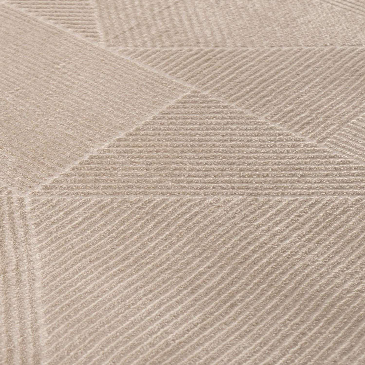 Close-up of a textured beige rug with geometric patterns, ideal for any modern home decor