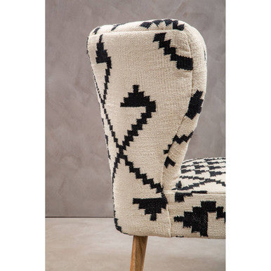 Orsina Berber Style Chair with a unique black and white geometric pattern and wooden legs