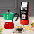 Bialetti Coffee Maker in green and red with a cup of espresso and coffee pack on the side