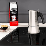 Bialetti Coffee Maker in stainless steel with coffee cup and Brew Italia coffee bag in the background
