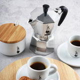 Bialetti Moka Express stovetop coffee maker with cups and sugar bowl for brewing authentic coffee