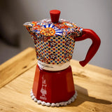 Bialetti Moka Express coffee maker with vibrant patterned lid and red base, perfect for brewing espresso