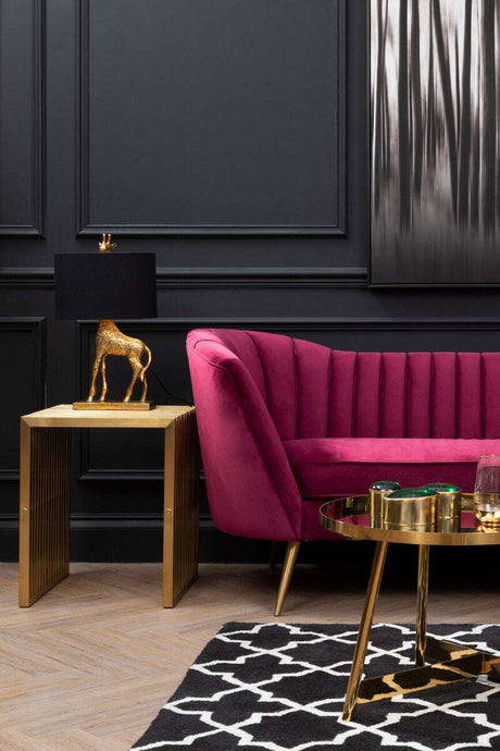 Stylish Black and White Rug placed under a gold and glass coffee table in a modern living room