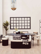 Stylish black throw draped over a patterned cushion in a modern dining setting