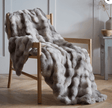 Luxury Faux Fur Throw in Soft Grey Draped on a Wooden Chair for Elegant Home Decor