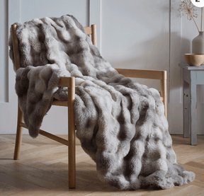 Luxury Faux Fur Throw in Soft Grey Draped on a Wooden Chair for Elegant Home Decor
