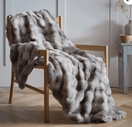 Luxury Faux Fur Throw in Soft Grey Draped on a Wooden Chair for Elegant Home Decor