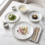 Elegant Bone China Dinner Set by KitchBoom featuring stylish plates and bowls on a marble table