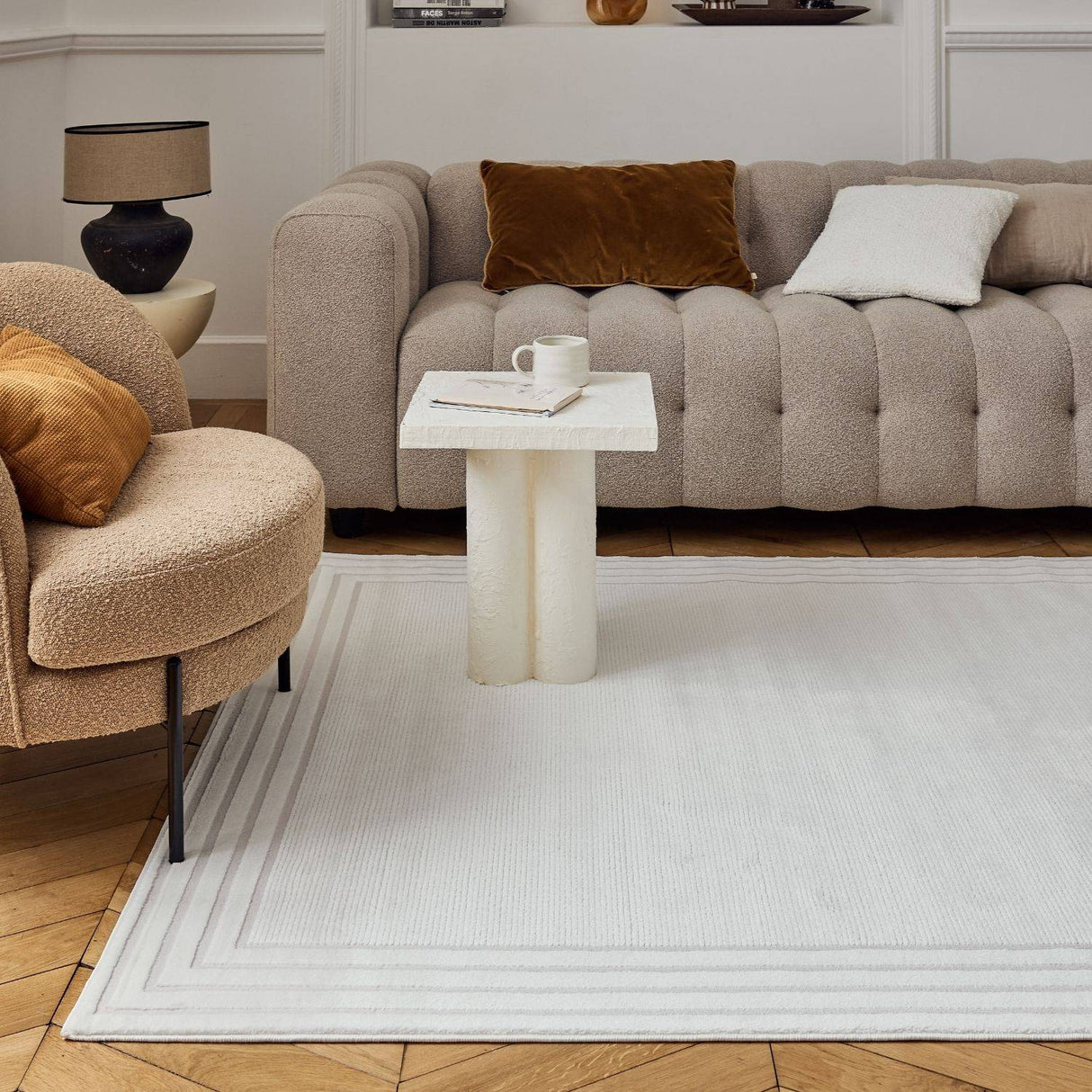 Elegant Bordered Rug in a stylish living room with plush furniture and decorative accents