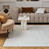 Elegant Bordered Rug in a stylish living room with plush furniture and decorative accents