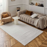 Neutral Bordered Rug displayed in a modern living room with a stylish sofa and elegant decor
