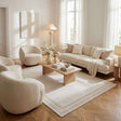 Stylish bordered rug in a modern living room with soft neutral tones and contemporary furniture
