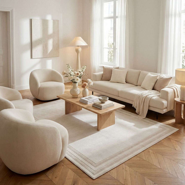 Stylish bordered rug in a modern living room with soft neutral tones and contemporary furniture