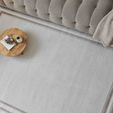 Stylish bordered rug in light grey with a delicate border, perfect for modern living spaces