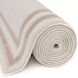 Plush Bordered Rug in beige and cream, showcasing a rolled design for versatile home decor