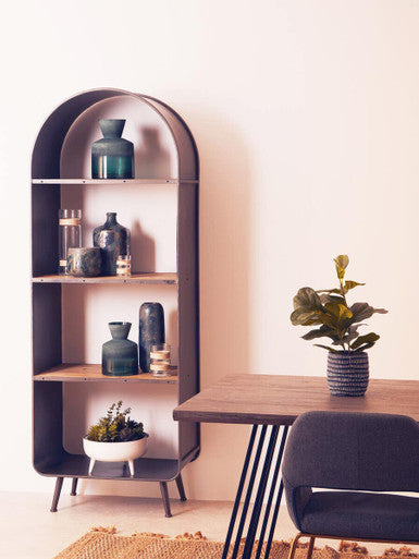 Stylish Orsina Bottle Vase displayed on a shelf alongside decorative glass bottles in a modern interior