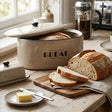 Orsina Bread Bin in Beige with Freshly Sliced Loaves and Butter on a Wooden Board