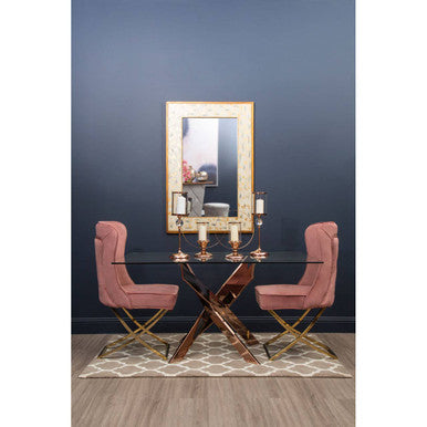 Elegant Brown and Natural Rug beneath a modern glass dining table with pink chairs and decorative candles