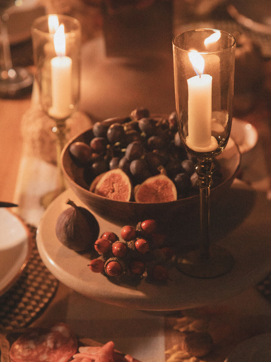 Orsina elegant cake stand showcasing fresh fruits and decorative candles on a beautifully set table