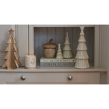 Elegant ceramic candle holders and decorative Christmas trees in a festive home setting