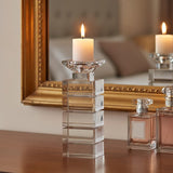 Elegant Orsina Candle Holder with a geometric design, displaying a lit candle on a wooden table