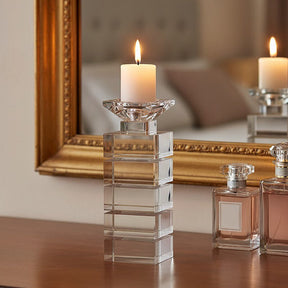 Elegant Orsina Candle Holder with a geometric design, displaying a lit candle on a wooden table