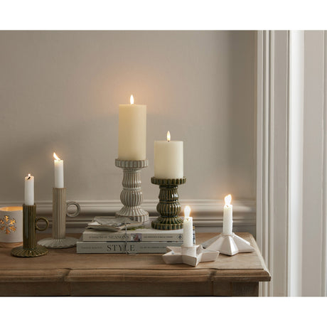 Elegant candle holders from Shades 4 Seasons showcasing various heights and styles on a wooden table