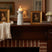 Elegant white Candle Holder on a rustic wooden mantel, surrounded by decorative frames and flowers