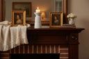 Elegant white Candle Holder on a rustic wooden mantel, surrounded by decorative frames and flowers
