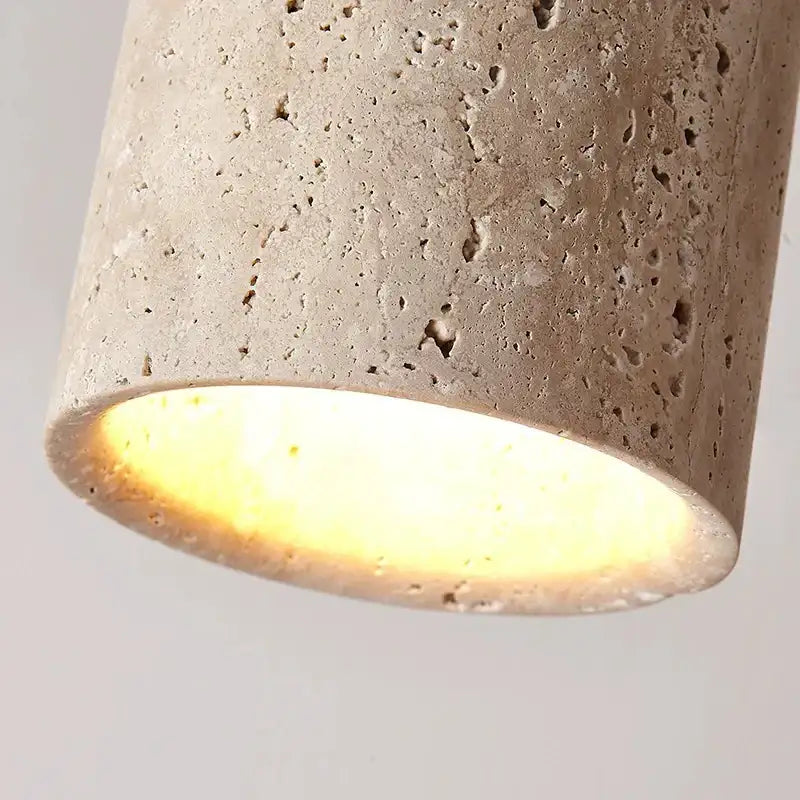 Nisu Home Ceiling Lamp in a textured stone finish, providing warm ambient light for modern interiors