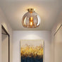 Glass Ceiling Light by Light My House with a modern design illuminating a hallway