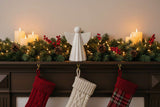 Ceramic Angel Decoration on a Festive Mantel with Stockings and Holiday Lights