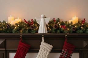 Ceramic Angel Decoration on a Festive Mantel with Stockings and Holiday Lights