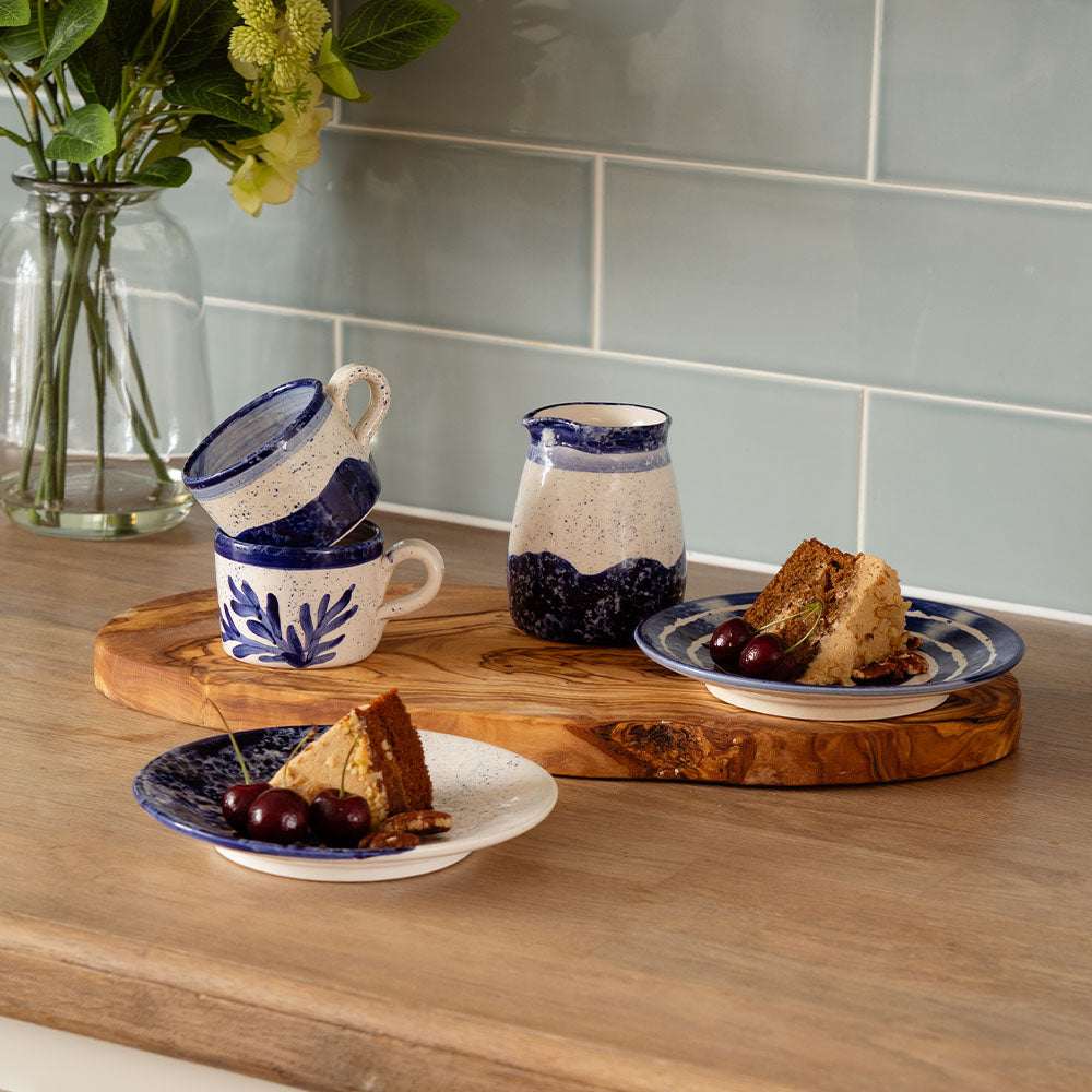 Set of Selbrae House ceramic espresso cups with matching plates, showcasing a blue floral design