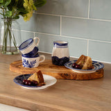 Set of Selbrae House ceramic espresso cups with matching plates, showcasing a blue floral design