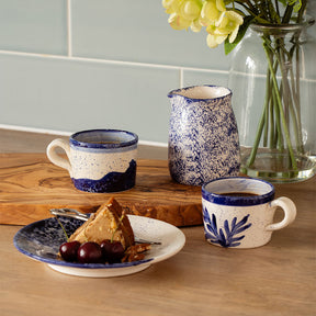 Stylish ceramic espresso cups from Selbrae House with a decorative design on a wooden table setting