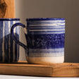 Selbrae House Ceramic Mug with Blue Striped Design and Glossy Finish on Wooden Surface